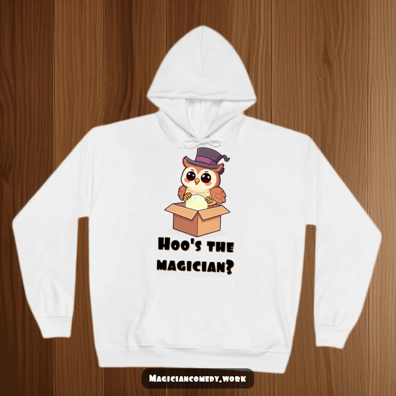 Funny owl magician hoodie showing a happy owl in a top hat pulling a glowing orb from a box, cozy and humorous.